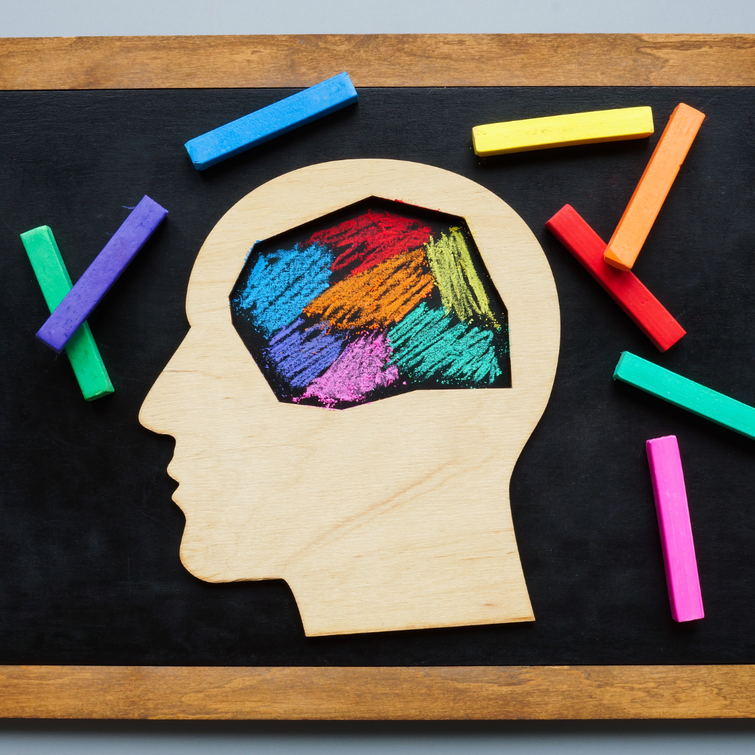 figura de la cabeza humana, donde la figura del cerebro esta coloreada por distintos colores, haciendo referencia a la neurodiversidad